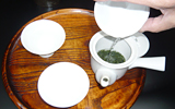 Pour the hot water into a tea pot.